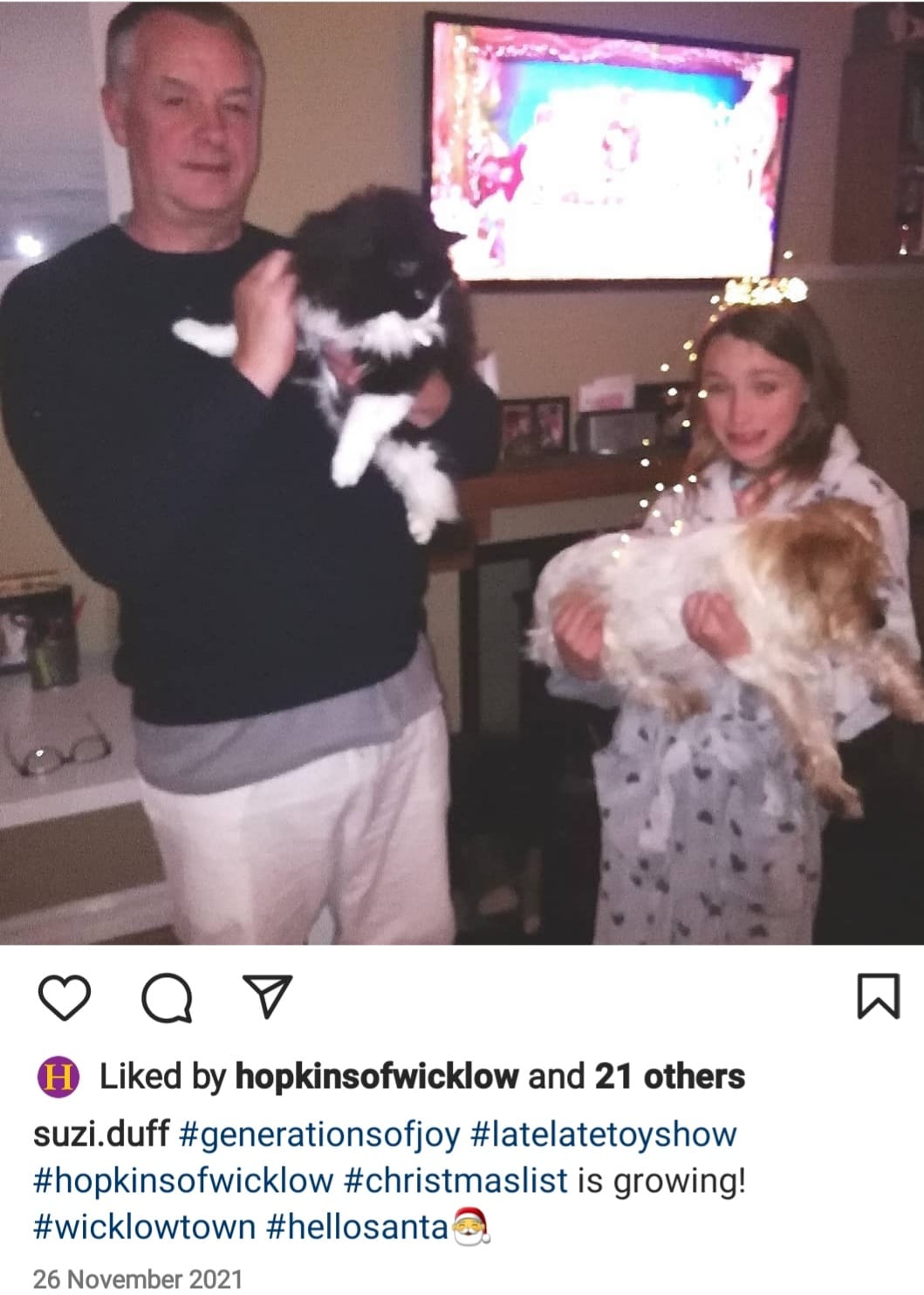 Family in pjs with cats watching Late Late toy show tagging Hopkins toy shop